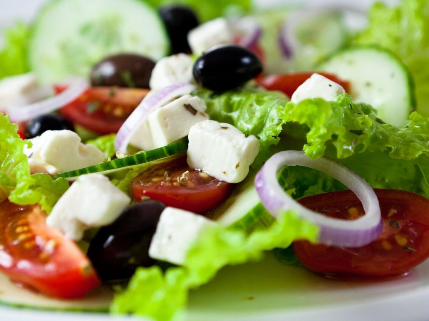 A greek salad presented in a glass bowl