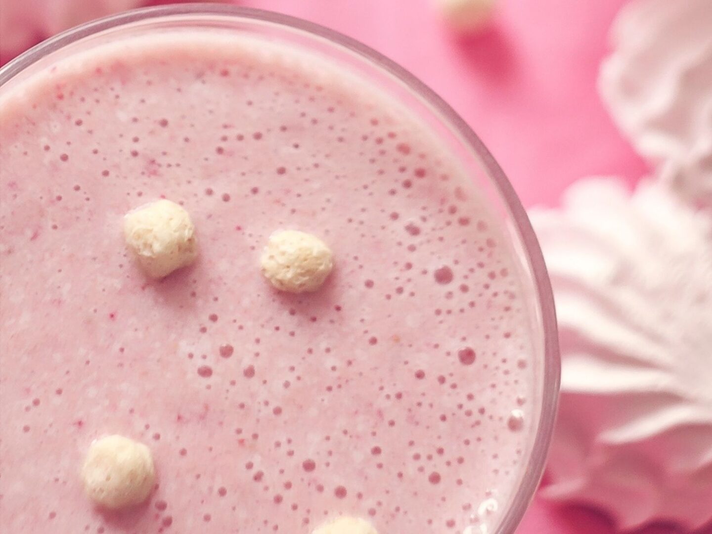 Strawberry angel delight with dream topping and meringue in a glass.