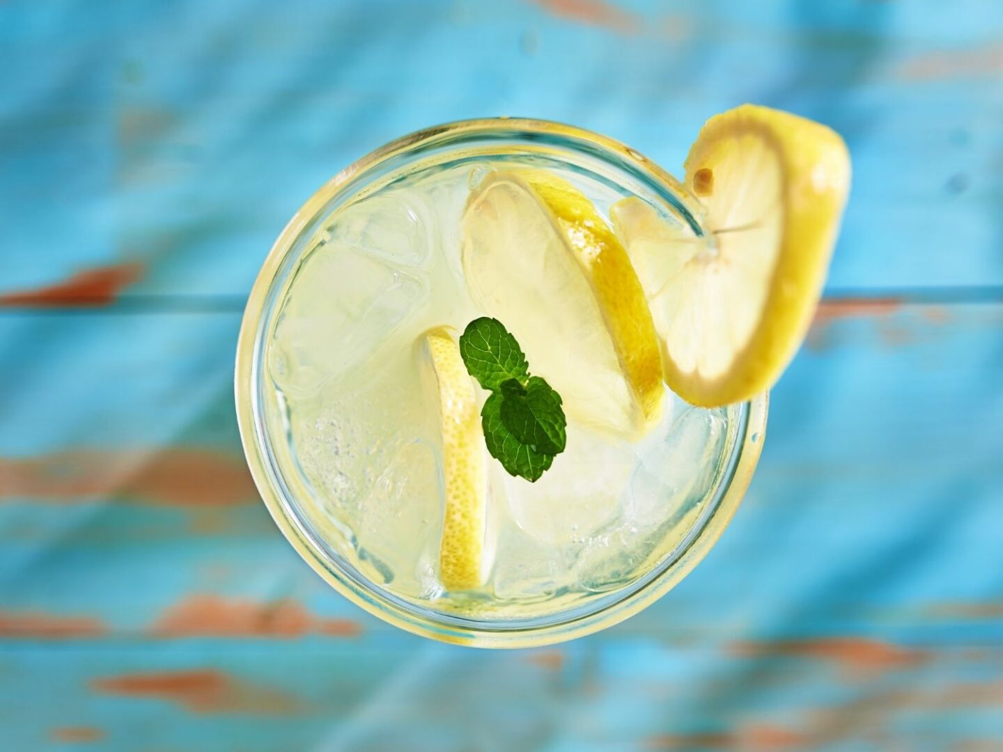 Homemade lemonade in a glass with sliced lemons