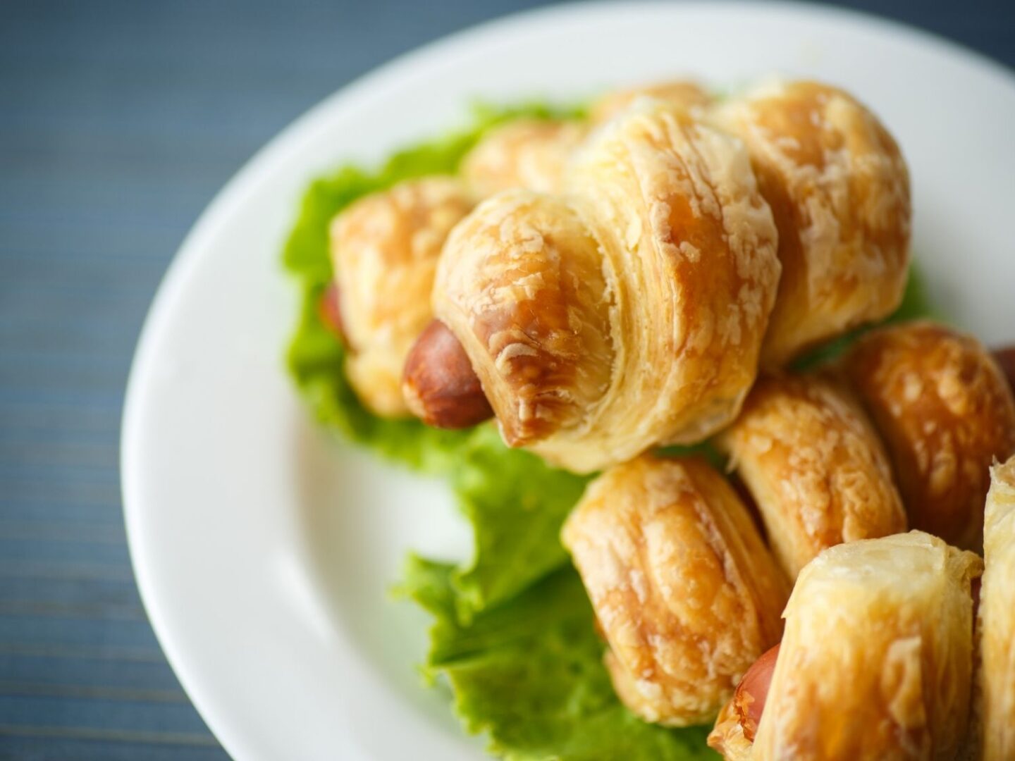 Sausage rolls with a twisted puff pastry outer.