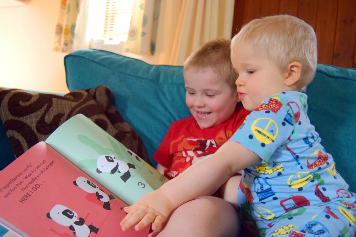 the boys looking at the super pop pom book