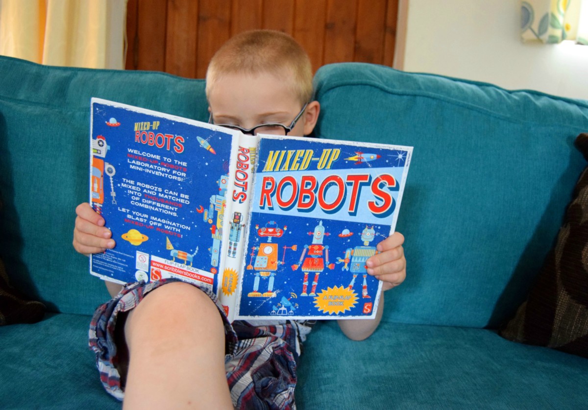 Little man looking at mixed up robots book
