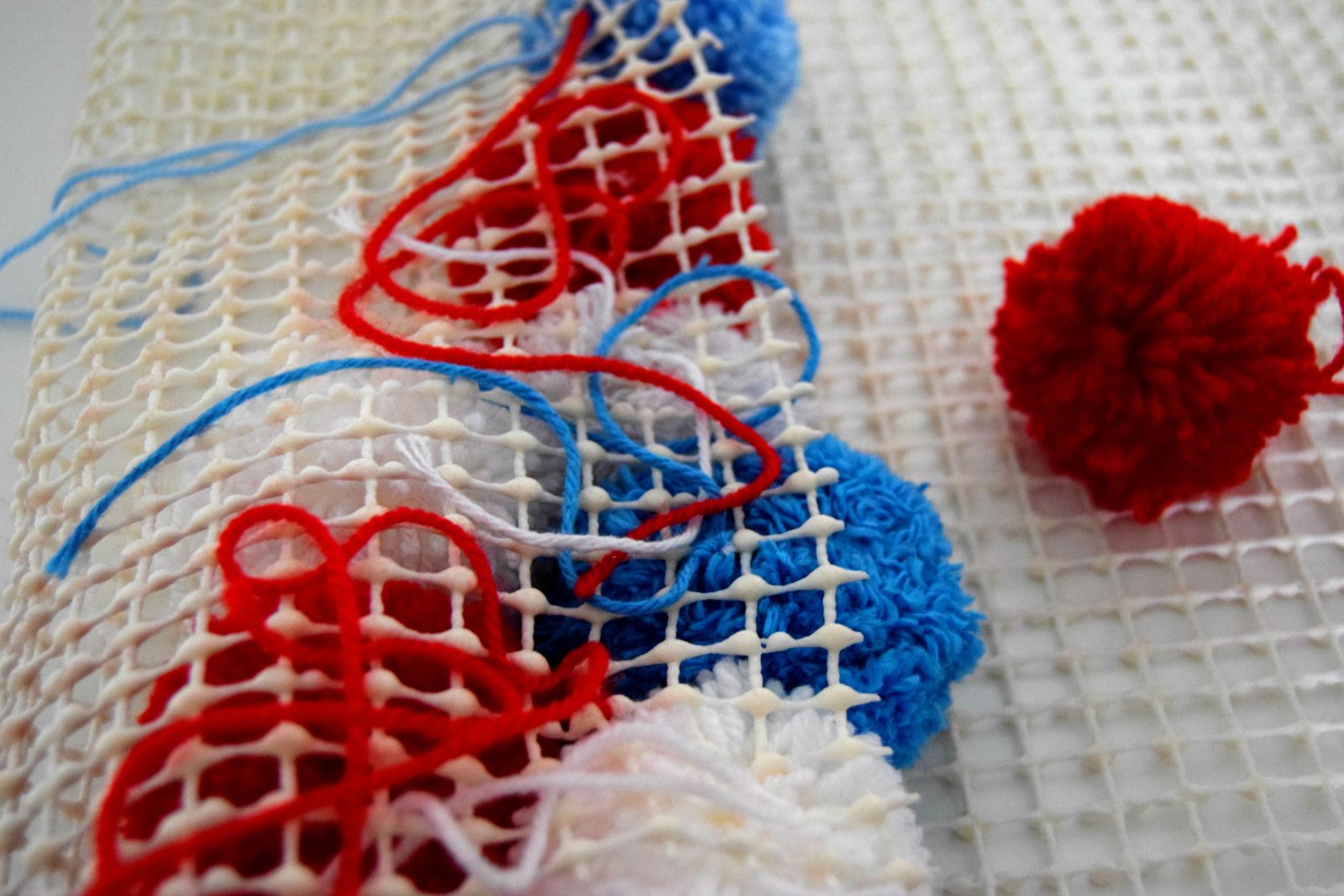 Tie the pom poms on
