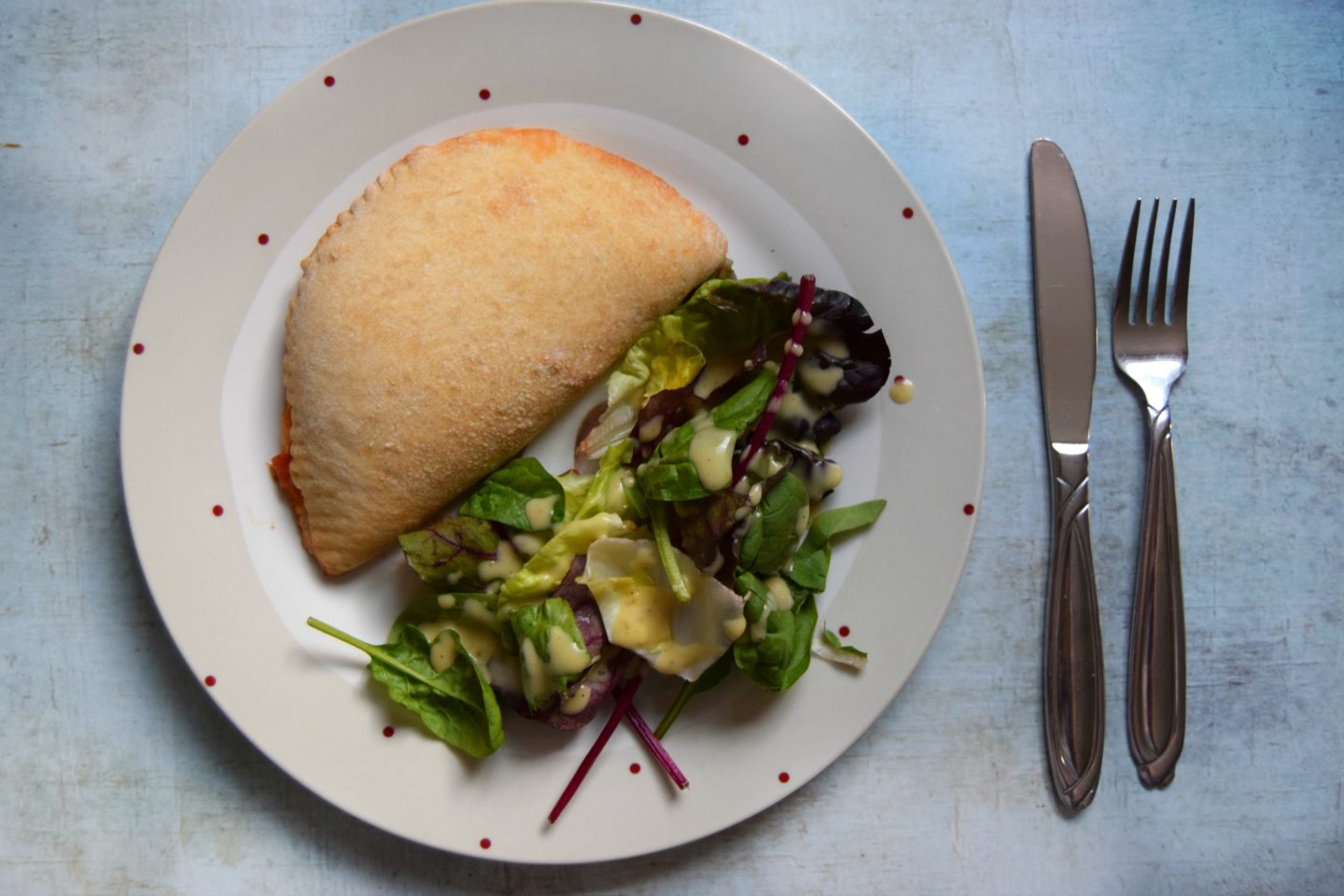 Cooked calzone with side salad