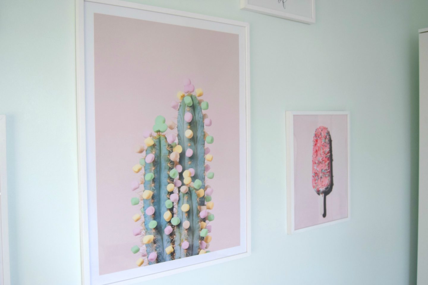 A fun cactus with pom poms and a pink popsicle poster from Desenio.