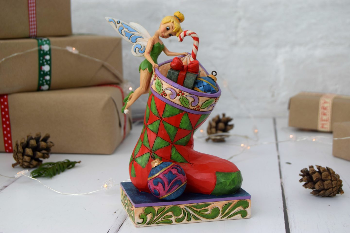 Tinkerbell Christmas figurine holding open a stocking.