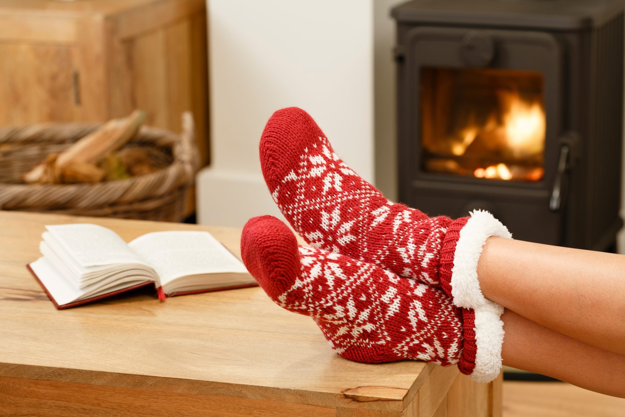 cosy living room with a person resting their feet on the coffee table.
