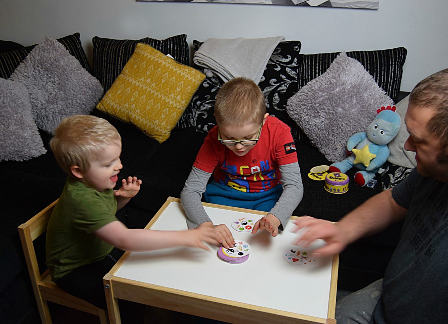 Playing the family card game Dobble on the table.