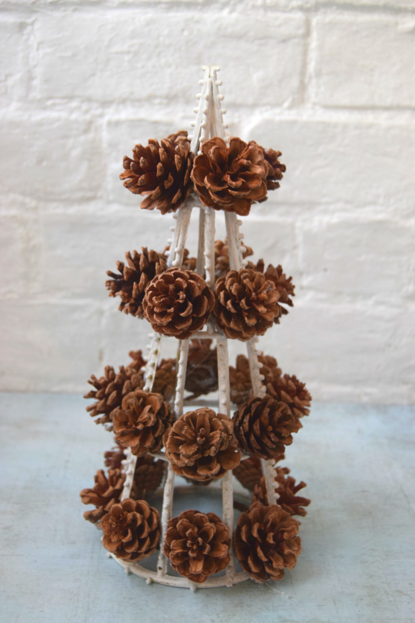 Attaching the pinecones to the base.