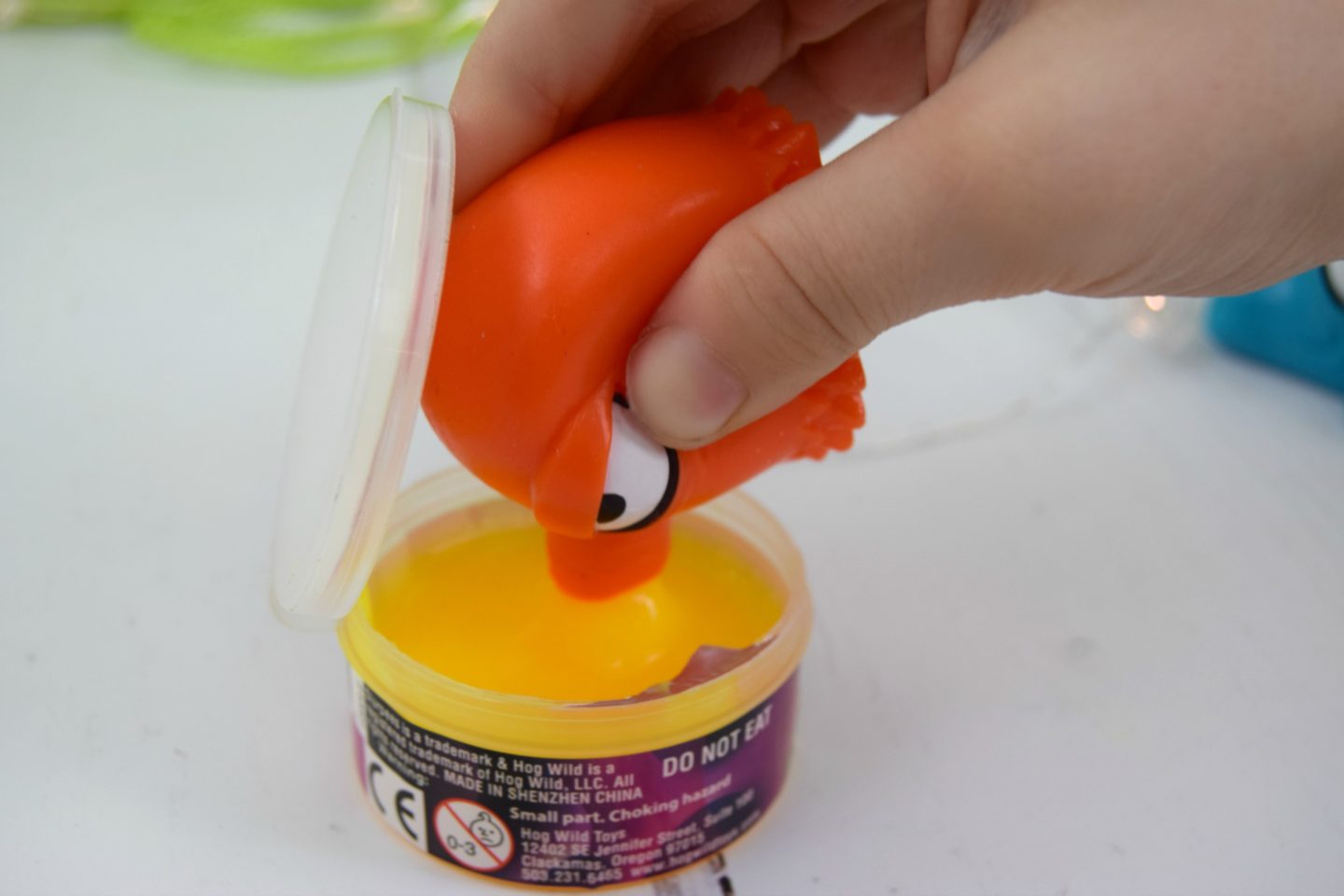 A Slurpees Snot Sucker sucking up a pot of yellow slime.