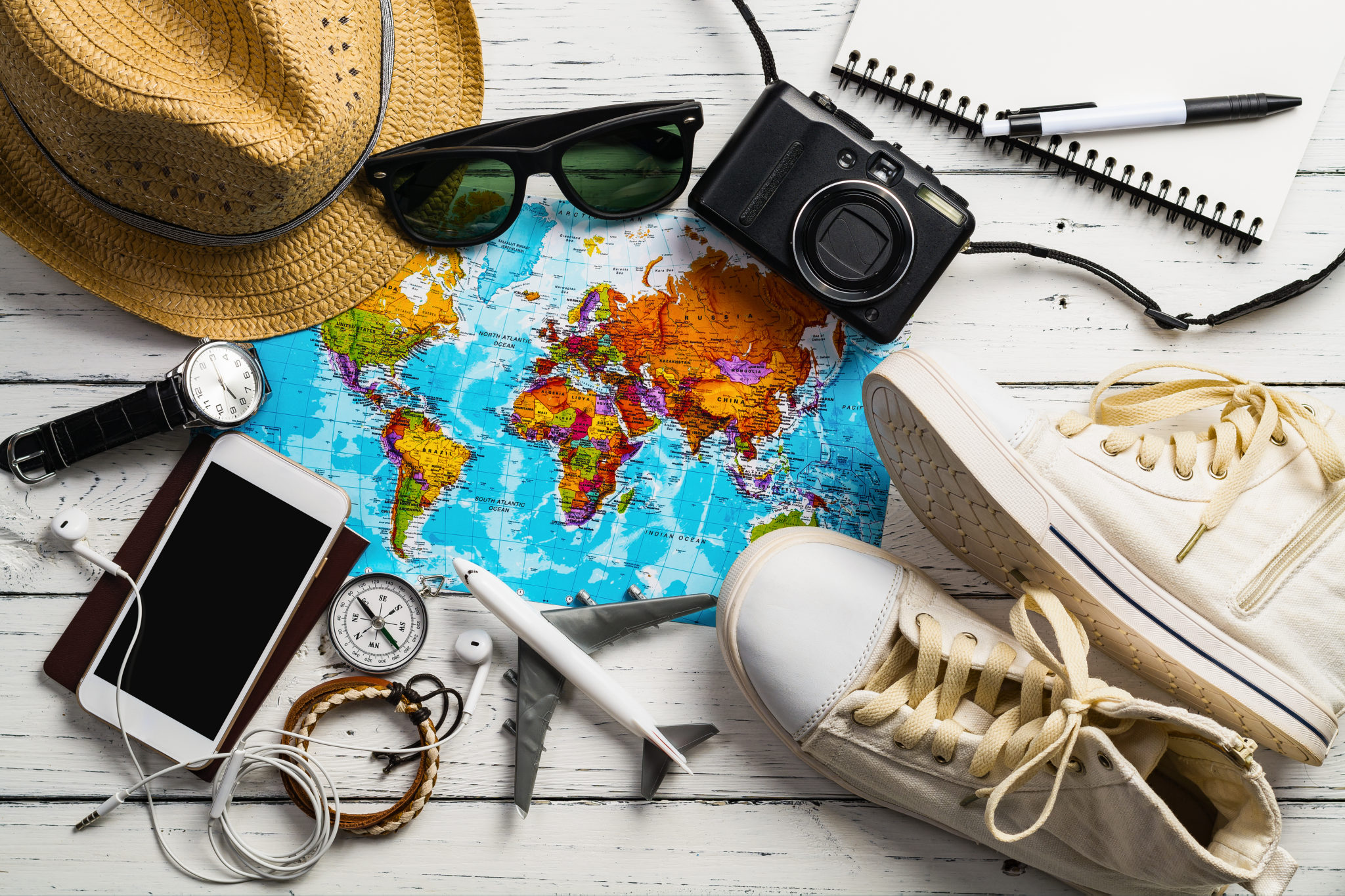 Travel accesories and a world map.