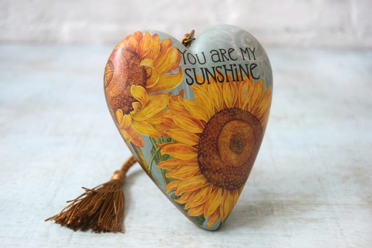 Art hearts range. A heart ornament with you are my sunshine printed on front.