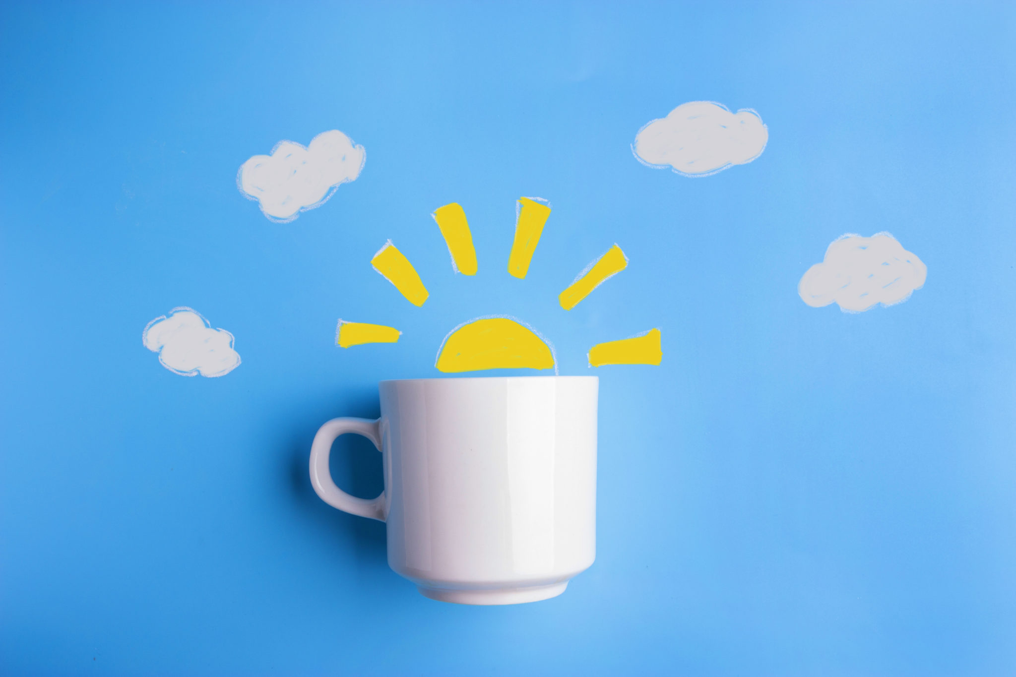 A mug with sunshine sketched above it.