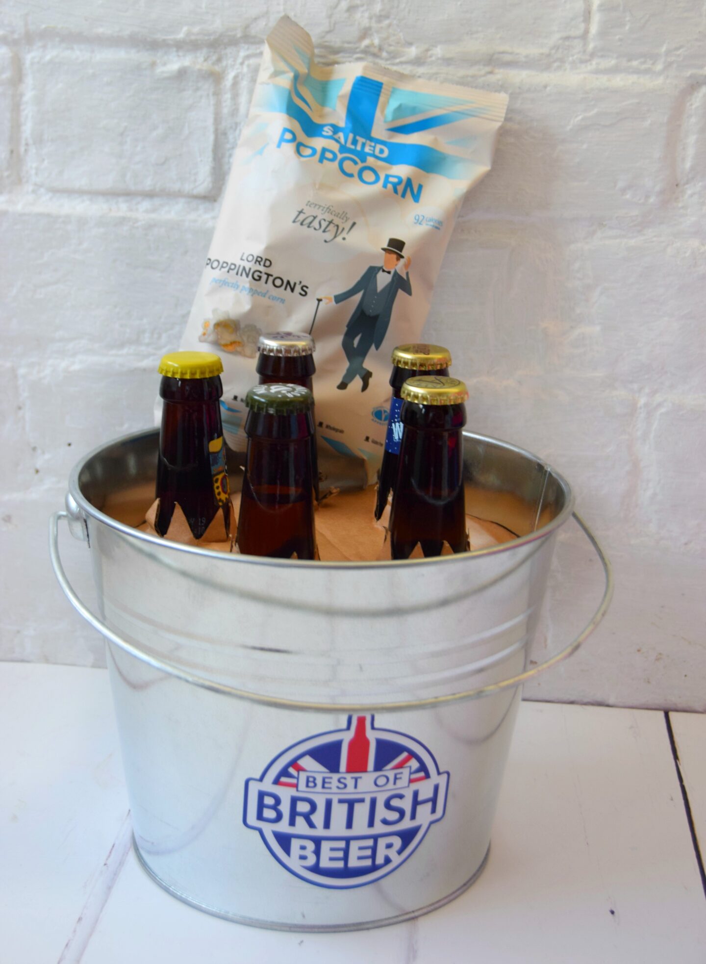 A beer gift. A bucket filled with different beers ad popcorn. Gifts for men that have everything.