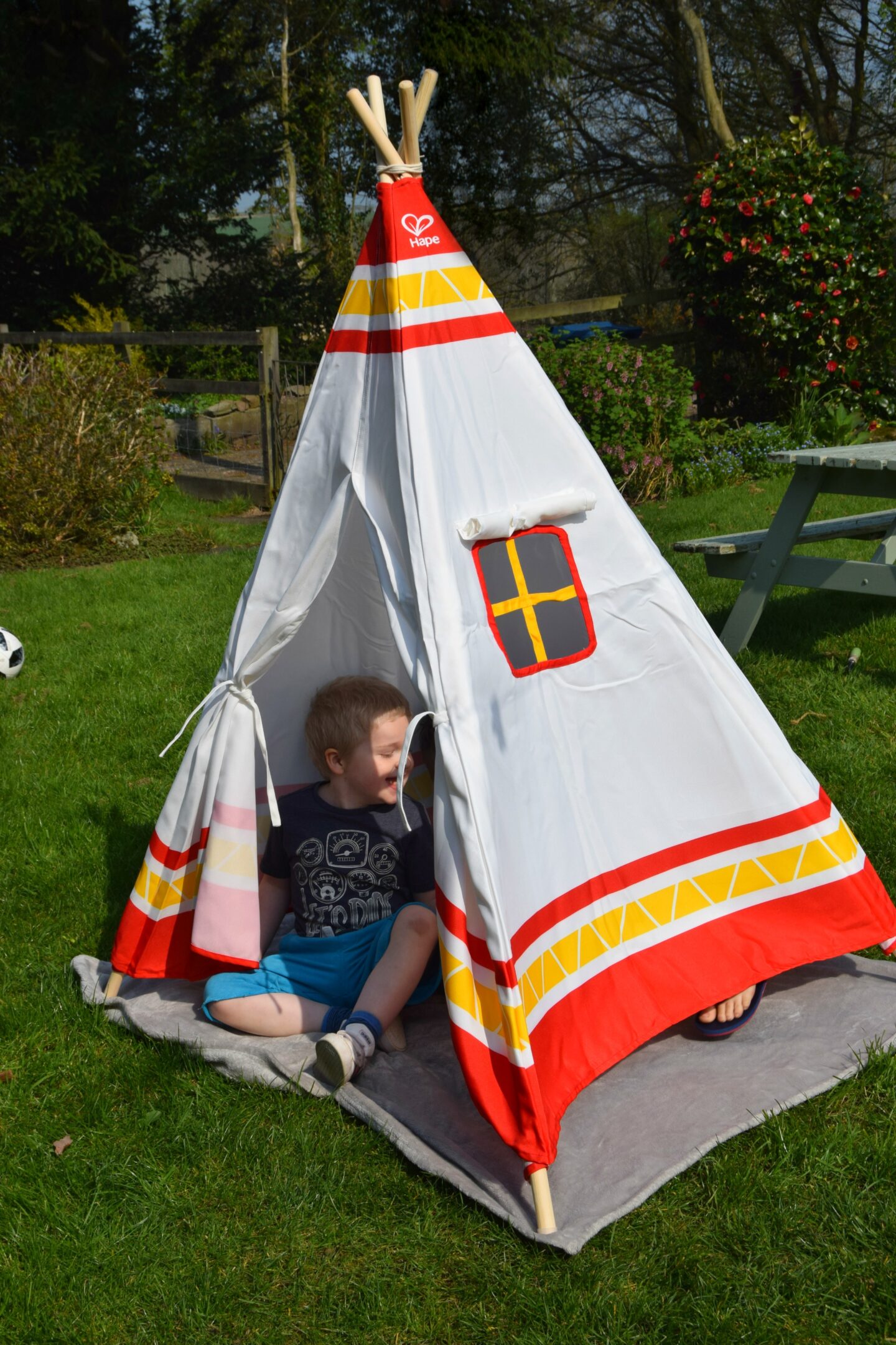 Children having fun in the kids indoor and outdoor Hape canvas teepee.