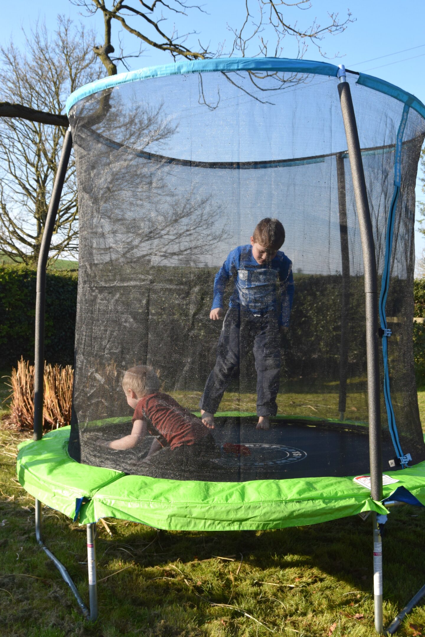 Playing outside on the trampoline. Home schooling activities