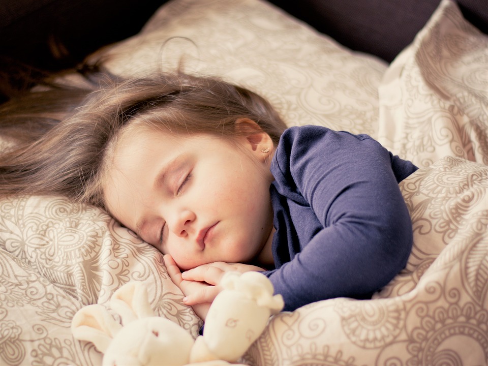 Child sleeping. Transition from cot to bed.