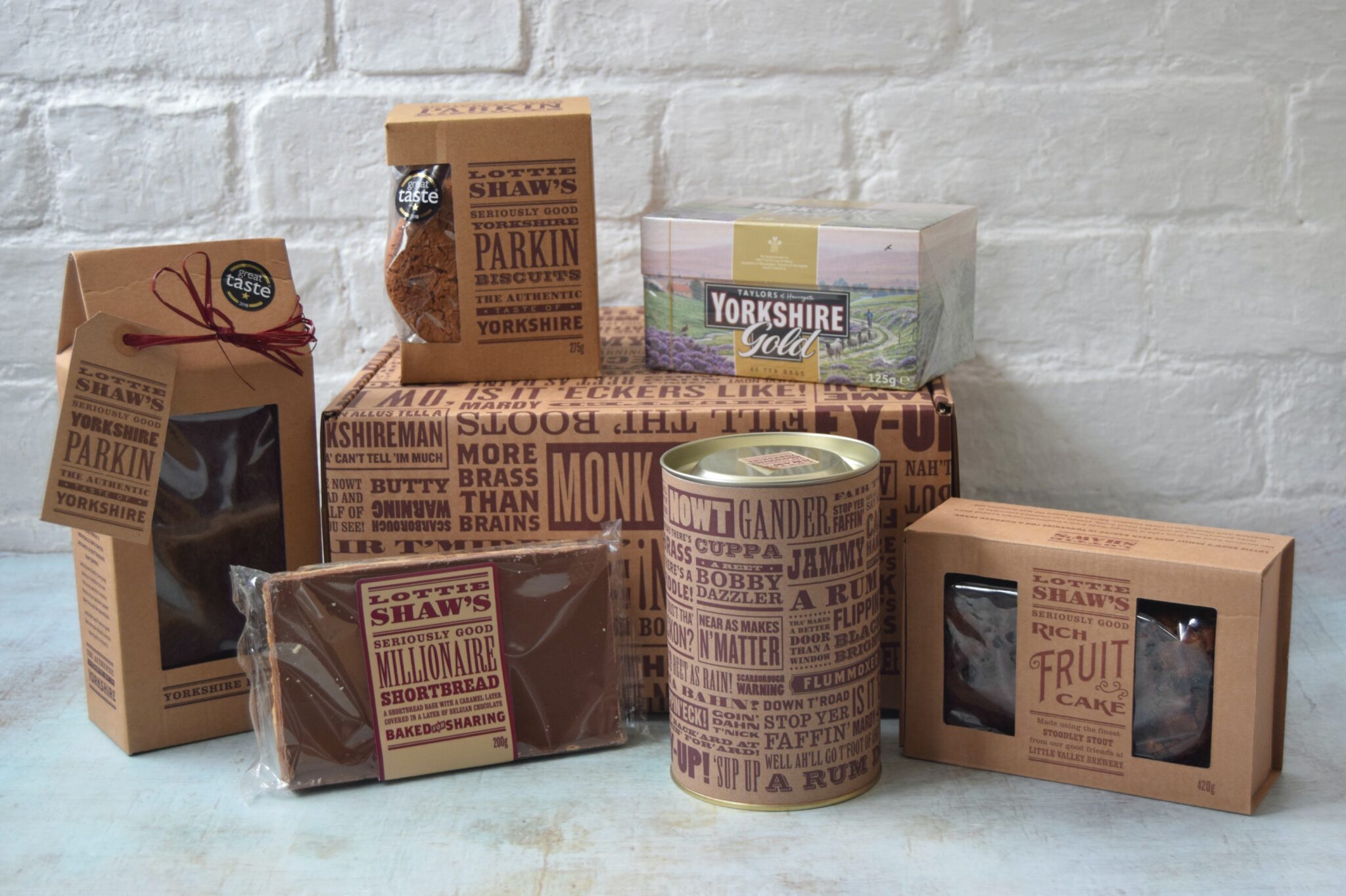 Yorkshire tea hampers for men. An afternoon tea hamper with parkin, cookies, teabags, rich fruit cake, millionaire's shortbread and hot chocolate.