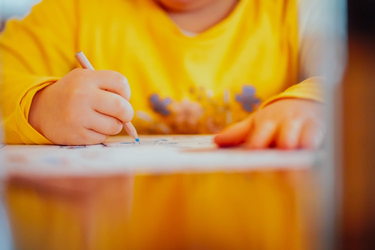 A child drawing on some paper