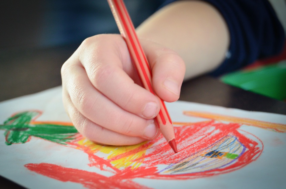 A child colouring in a picture of a helicopter