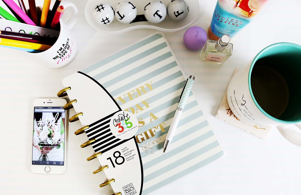 working desk with mobile phone. Getting the best mobile phone deals as a WAHM