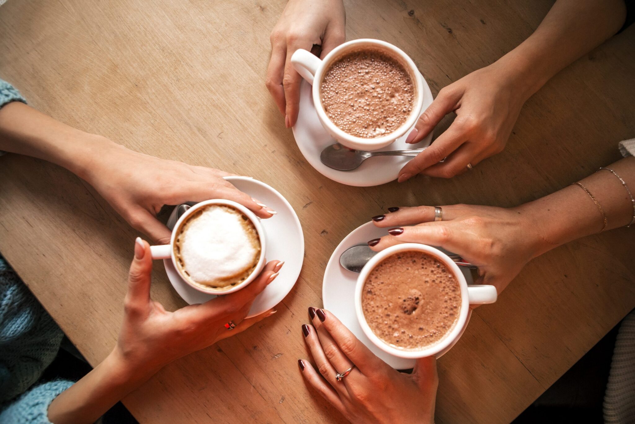 Three people enjoying a cup of tea together at a table. Monday Morning Blog Club