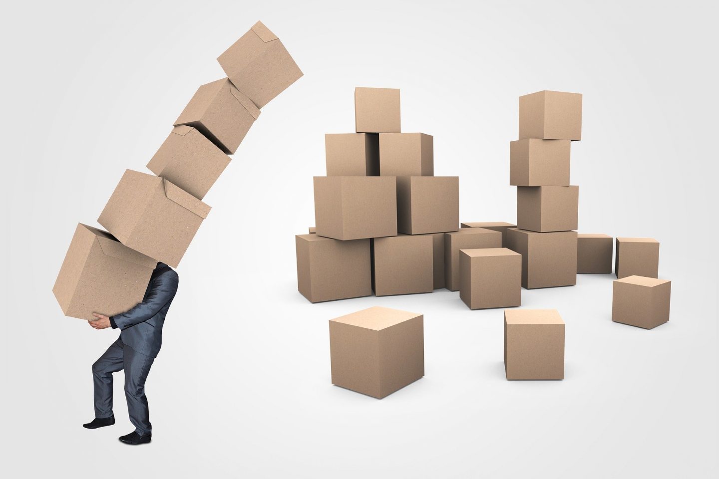 A man moving cardboard boxes
