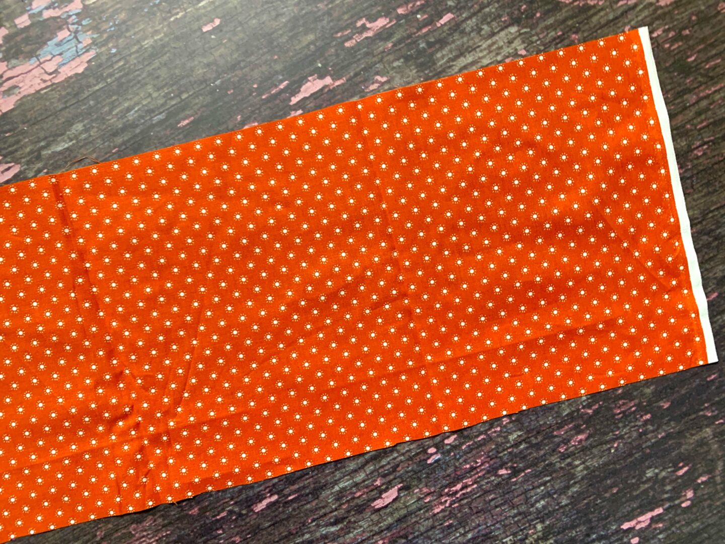 A cut to size piece of orange fabric