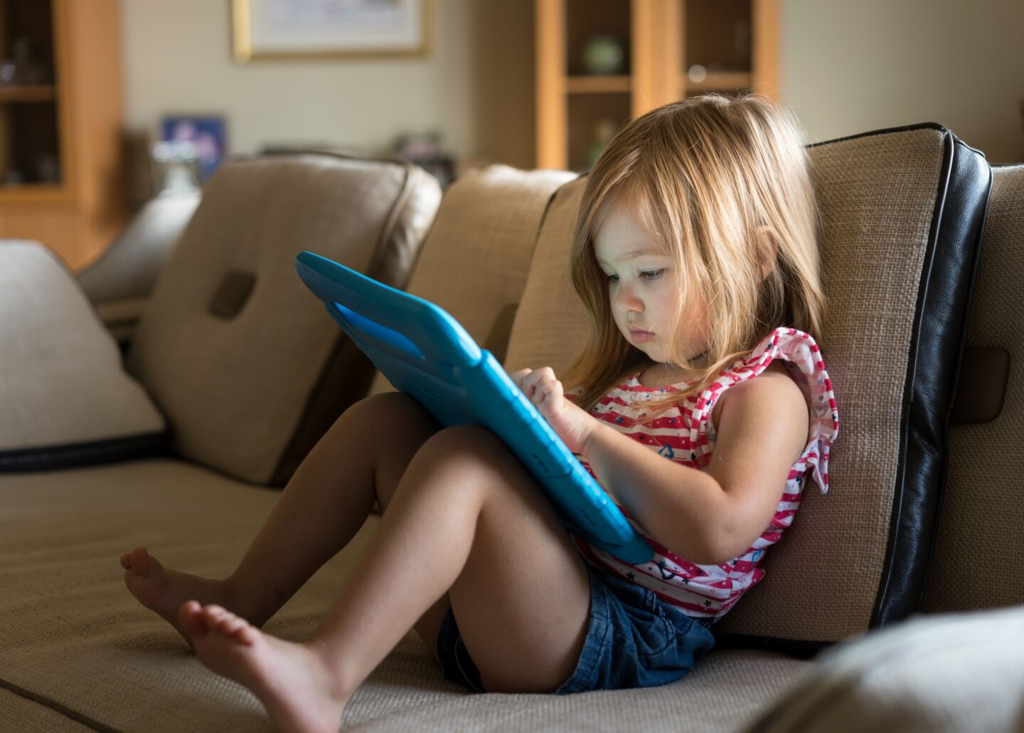 A preschool girl playing on an ipad