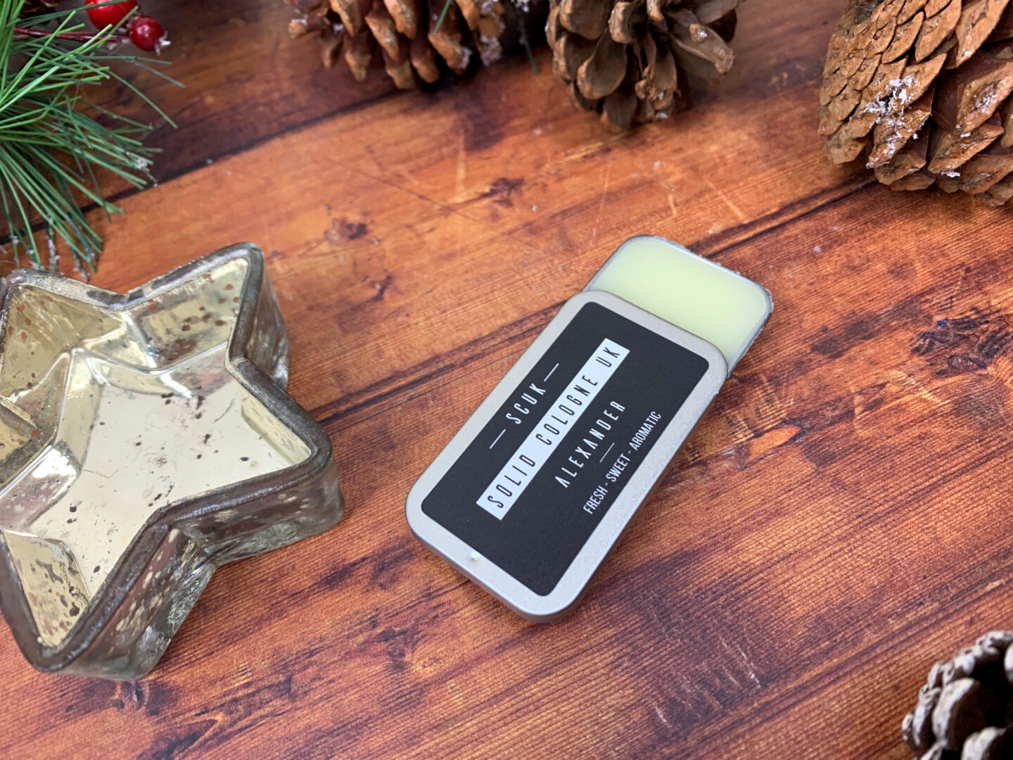 A solid cologne bar in a mini travel tin