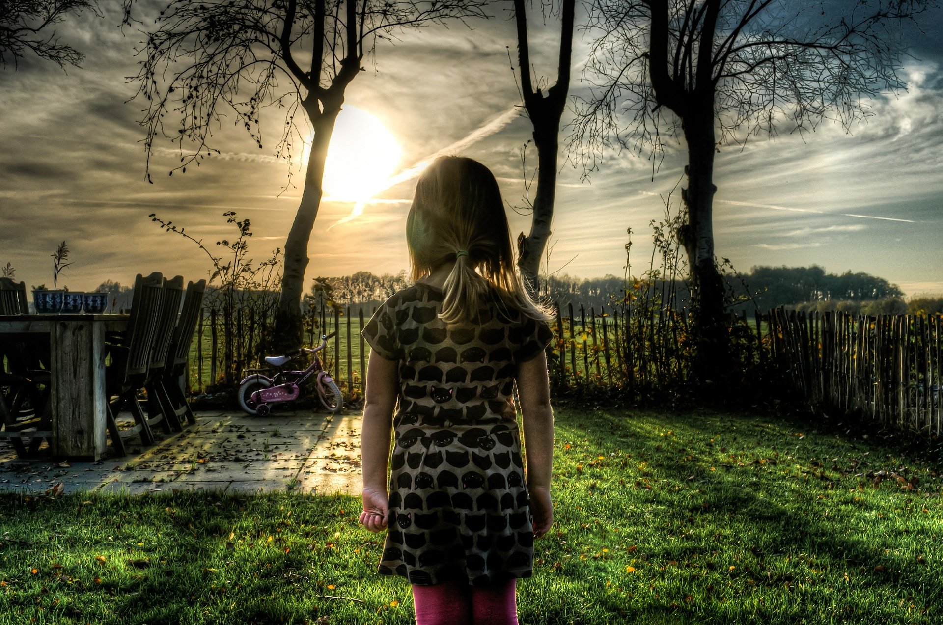 A little girl standing in a small garden