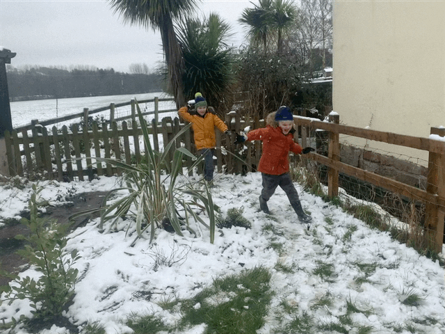 Children playing snowball fights in the snow