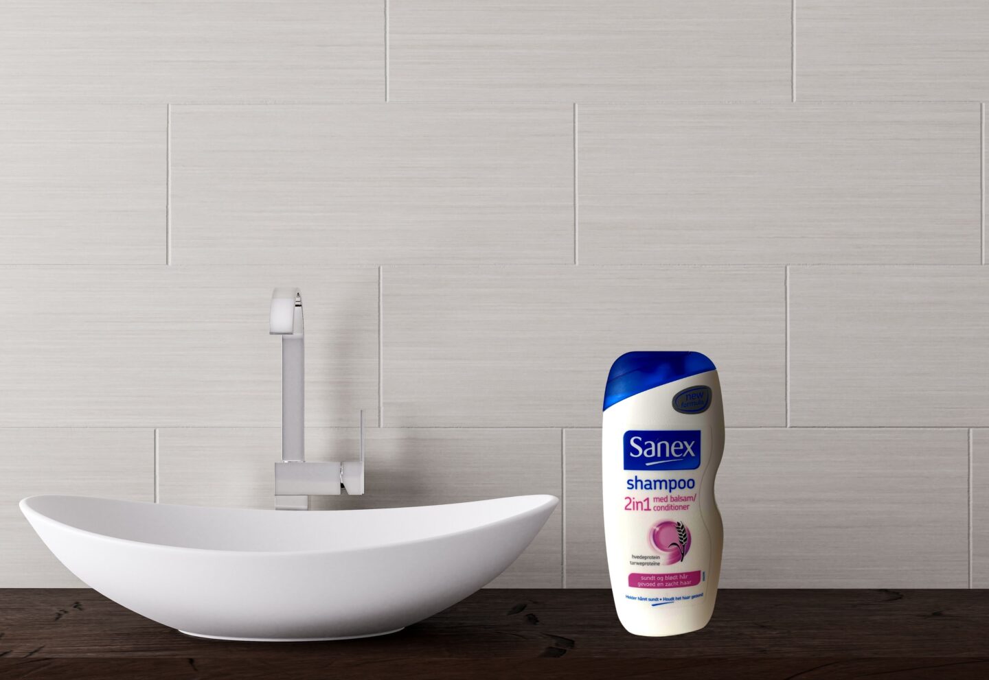 A bottle of Sanex 2 in 1 shampoo next to a sink