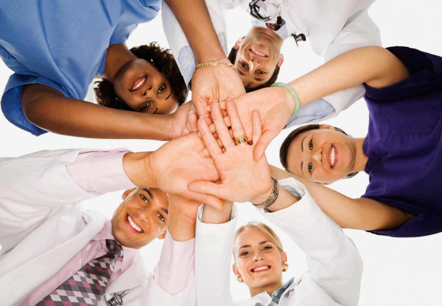 Healthcare staff all joining hands