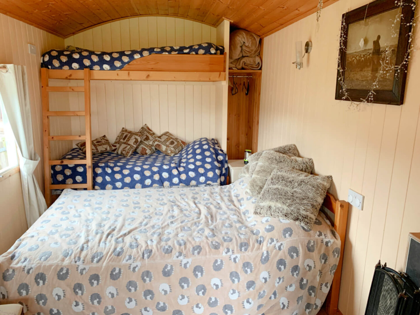 View of the bunk beds and double bed in the shepherd's hut.