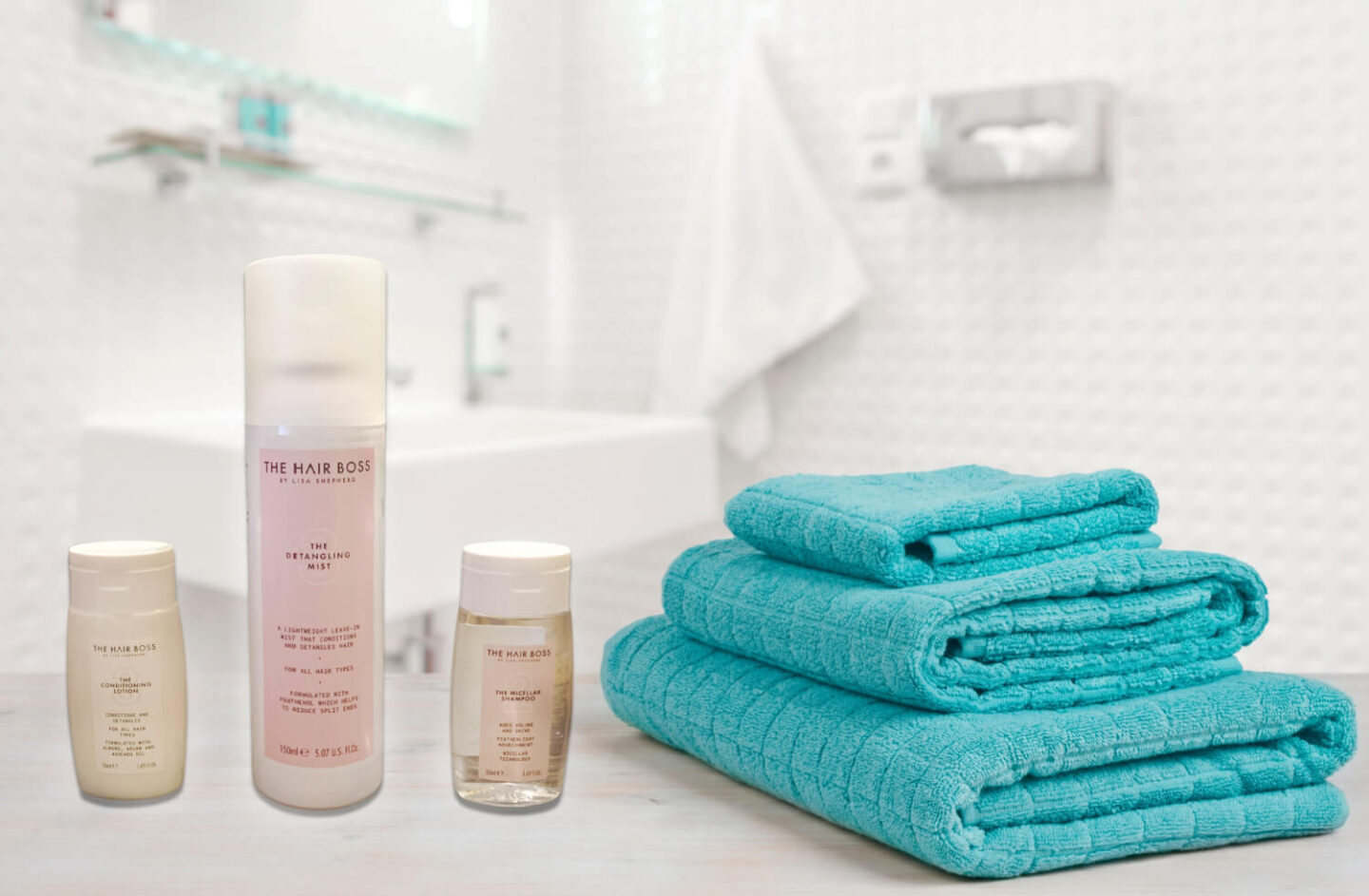 The hair boss detangling mist, shampoo and conditioner on a bathroom worktop