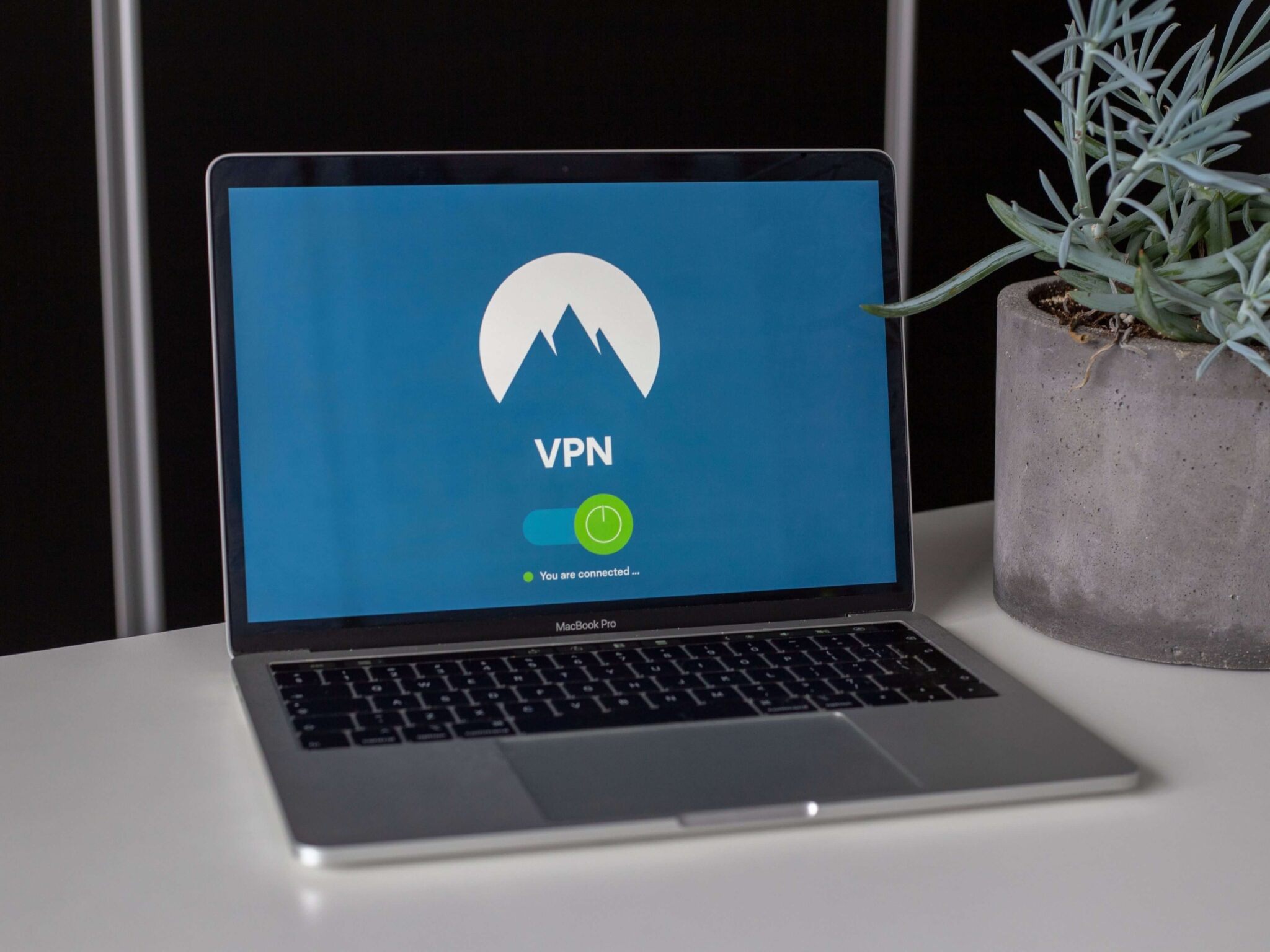 A laptop on a sideboard with a VPN network on show.