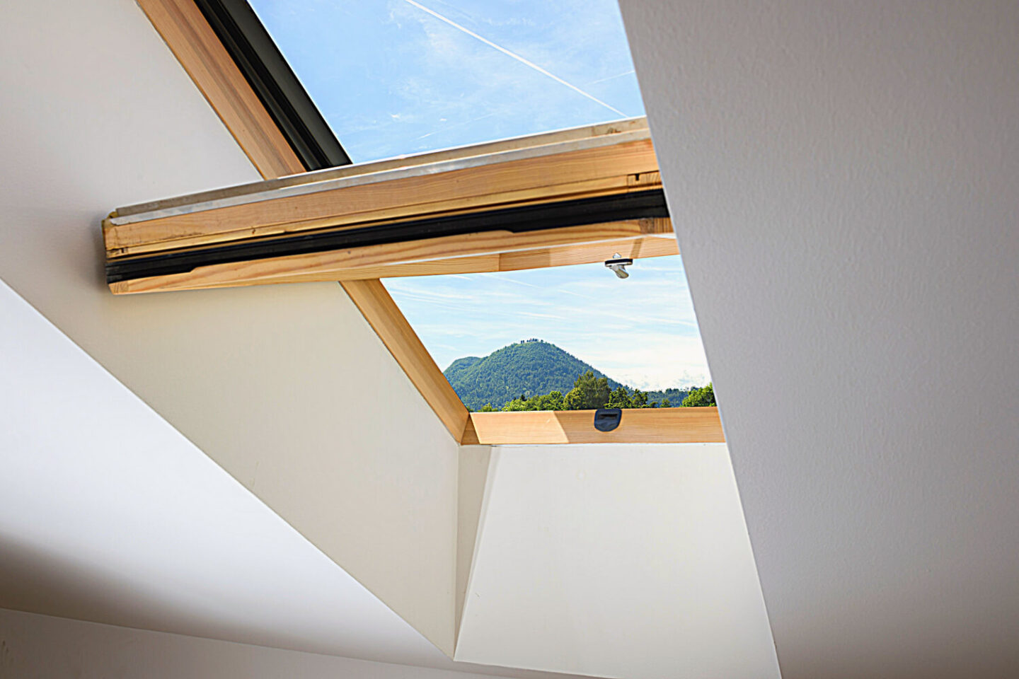 A light oak Velux window in the roof of a house.