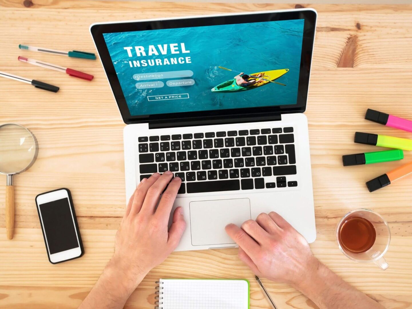 A man sat at a laptop getting a travel insurance quote.