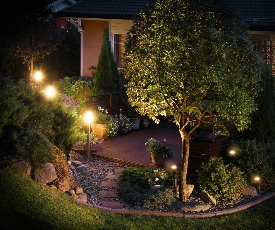 A small garden edged with pillar lights in the borders.