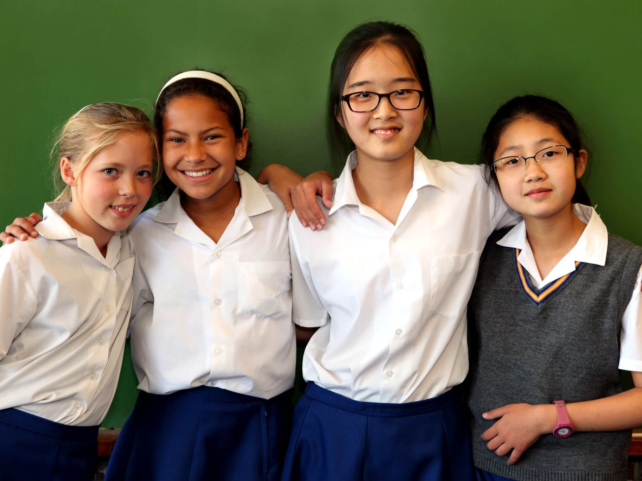 Four girls who are junior school students standing in a line.