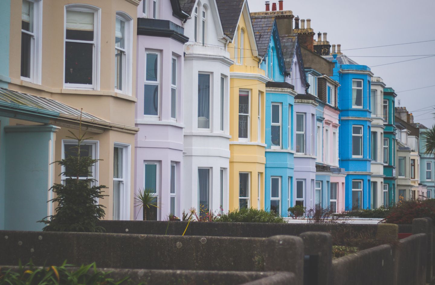 A row of terraced houses all painted in different colours.