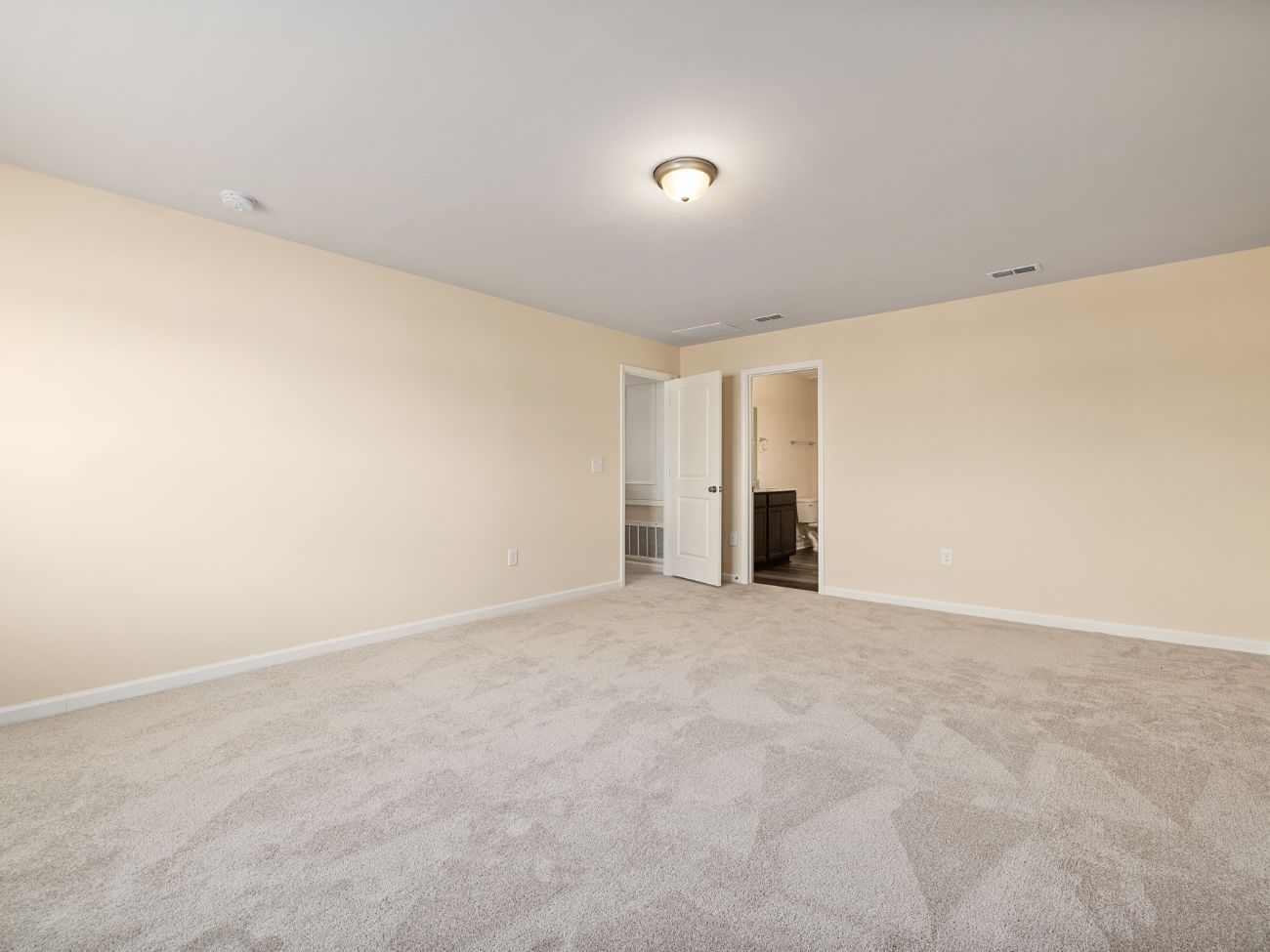 Cream carpet in a large cream room