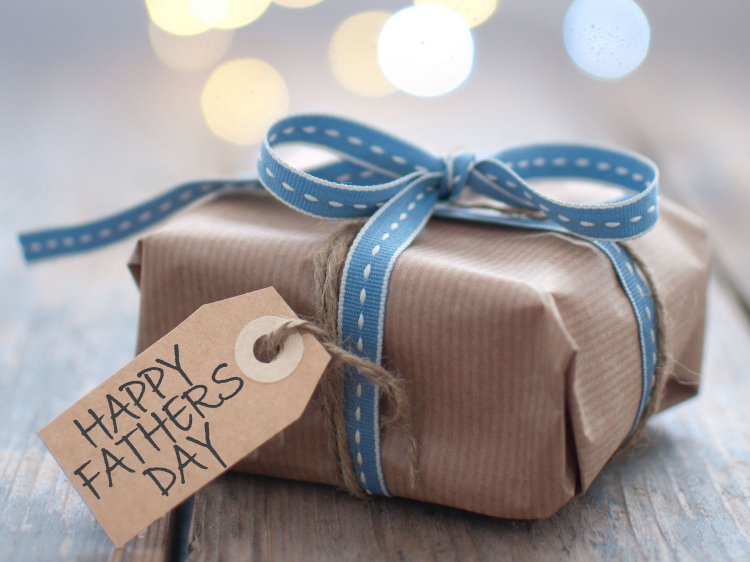 Father's Day gift guide 2025. A Pressie with a gift tag saying 'Happy Father's Day'.