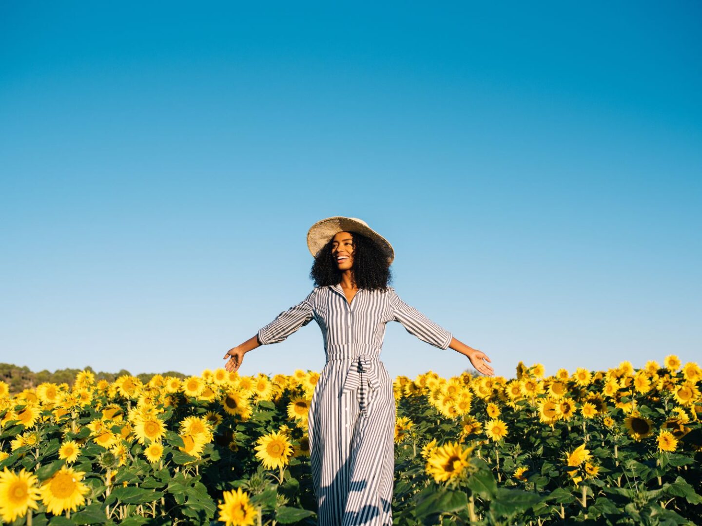 Lady in sunflower field