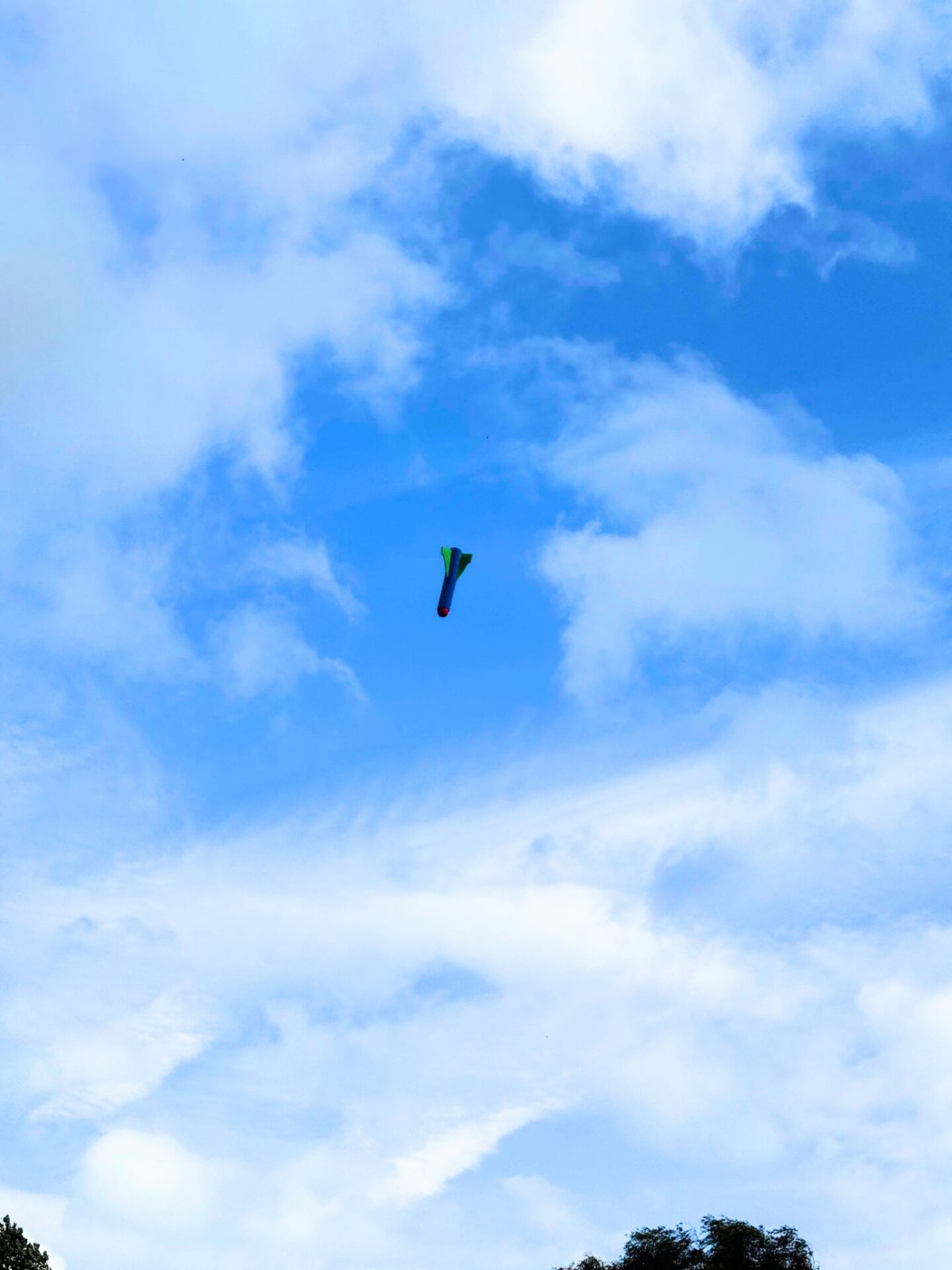 Toy hand rocket coming down from the sky.