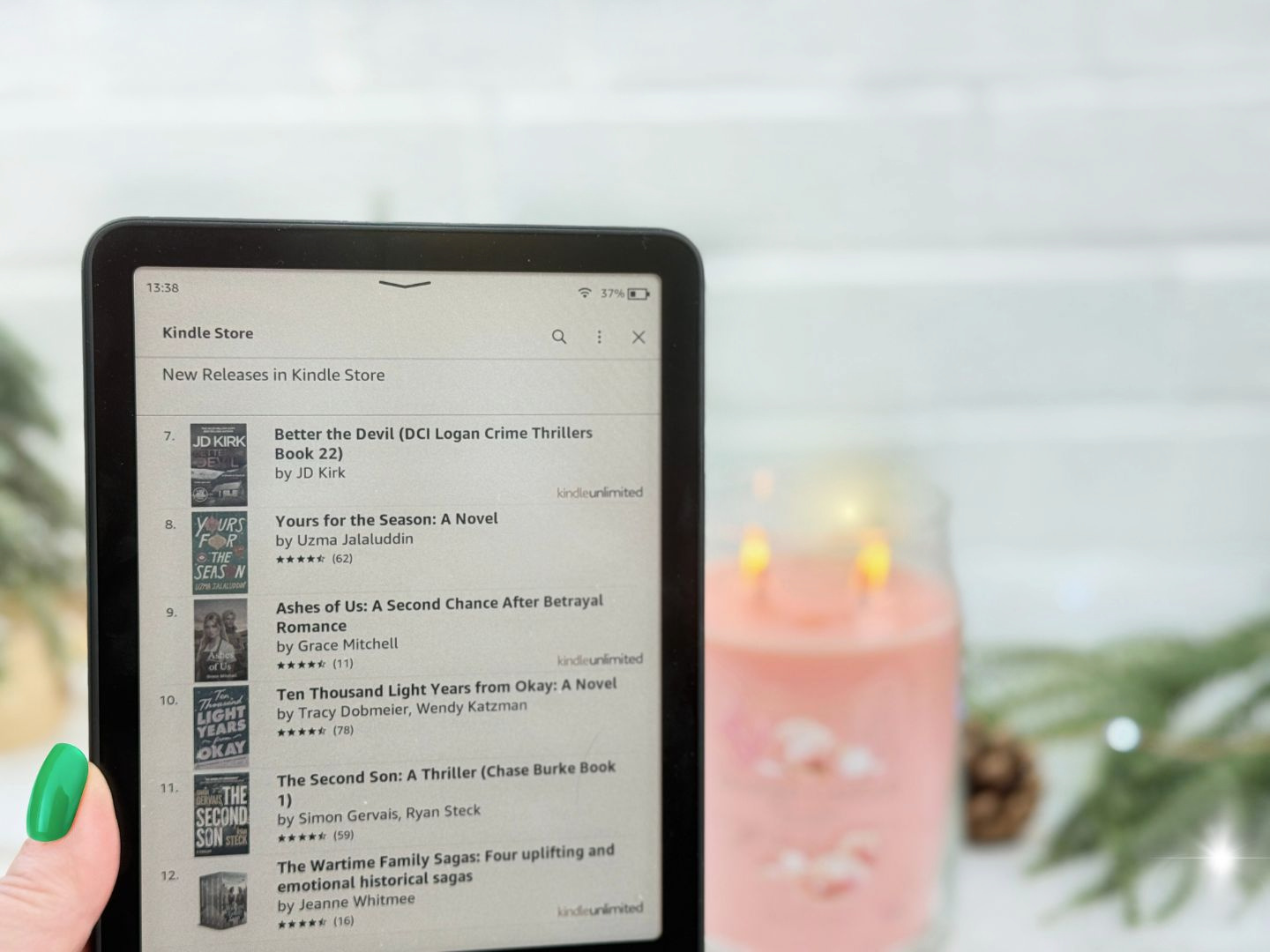My kindle with a candle in the background 1